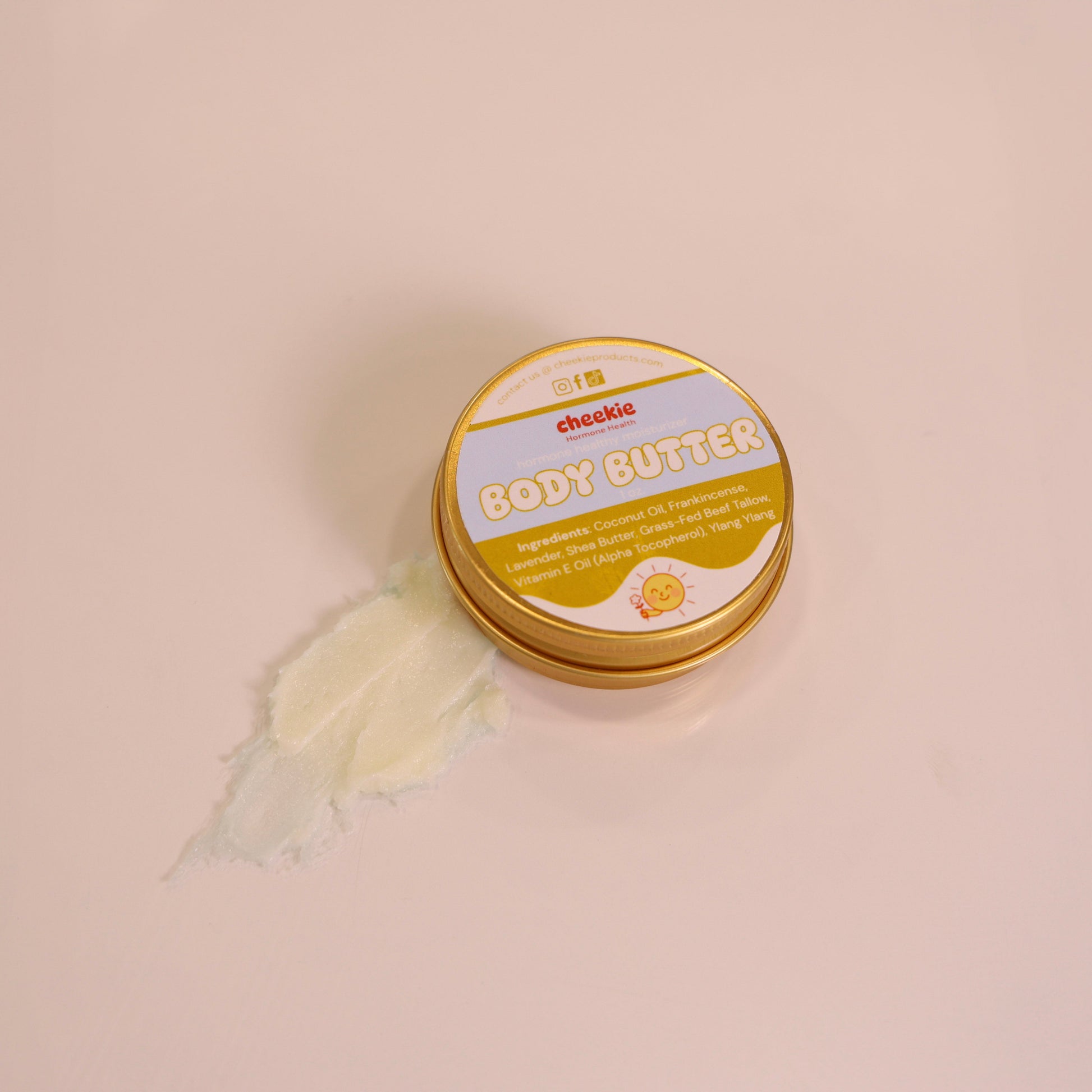Jar of body butter with a white label on a beige background