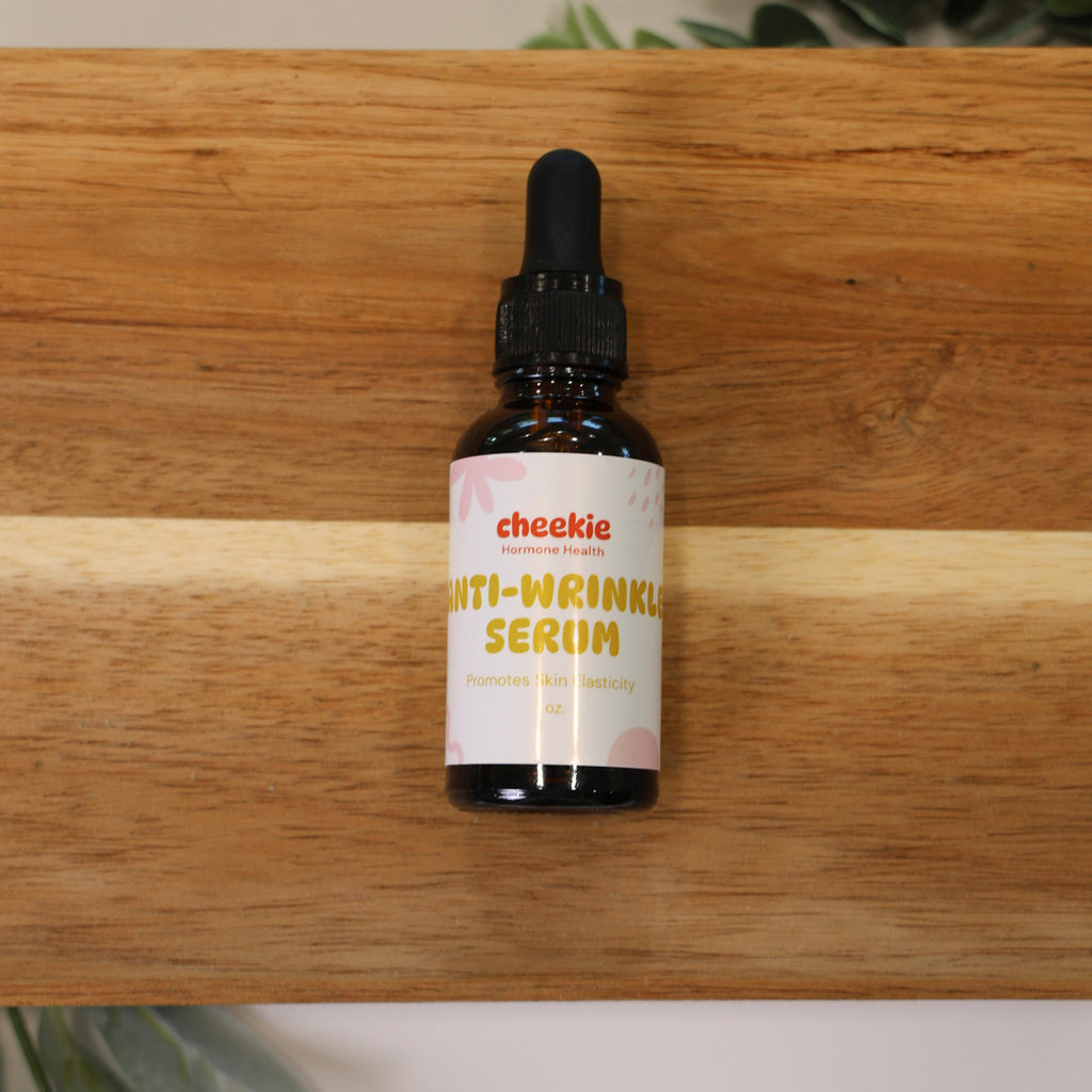 Bottle of cheskie anti-wrinkle serum on a wooden surface with plants in the background